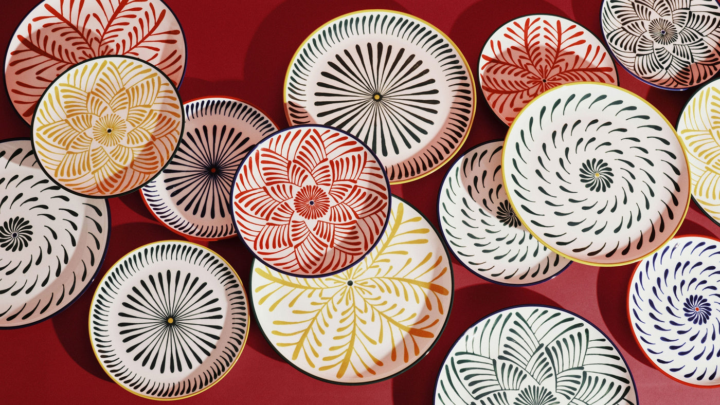 Colorful table setting with hand-painted plates by Serax